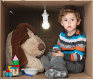 Boy playing in cardboard box