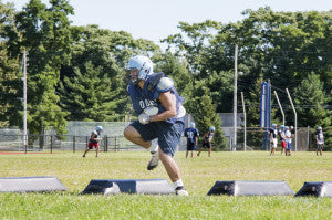 high school football player training in hot weather