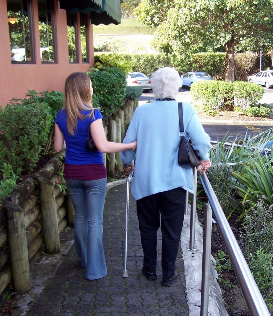 Walking elderly woman down ramp