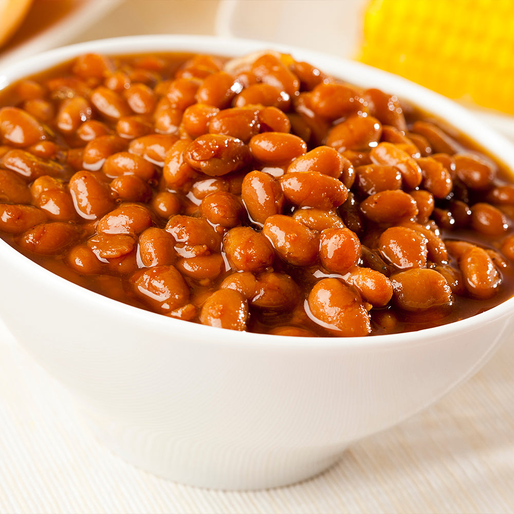 teaming Hot Barbecue Baked Beans in a White Ceramic Bowl with a Golden Background