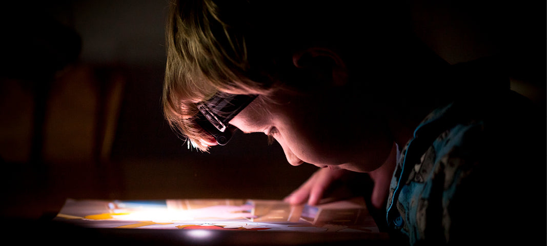 Child reading in dim light