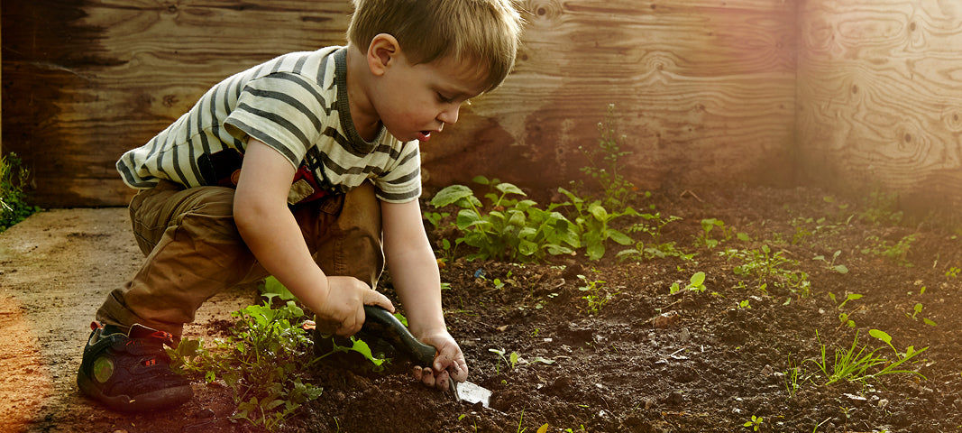 child digging in the dirt