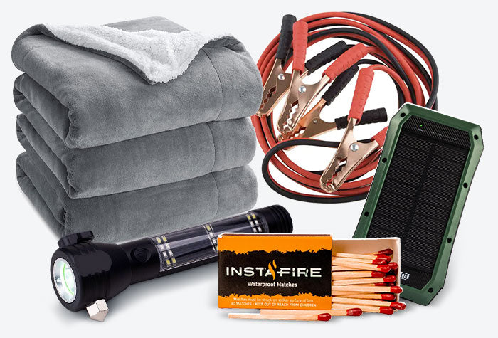 Winter Car Emergency Kit containing blankets, a flashlight, matches, and jumper cables.