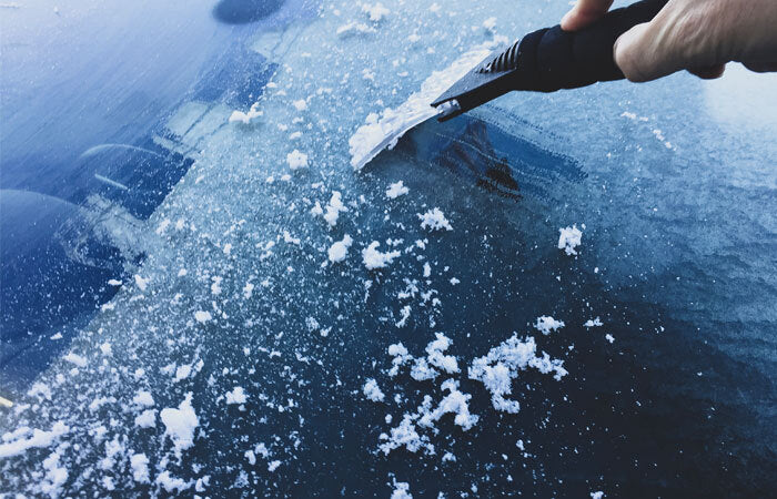 scraping ice off a windshield