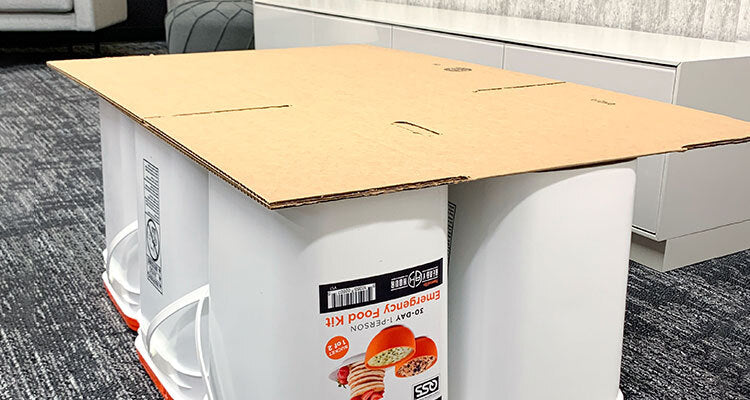 cardboard sitting on emergency food buckets