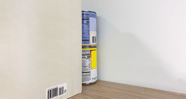 tin cans behind a shelf
