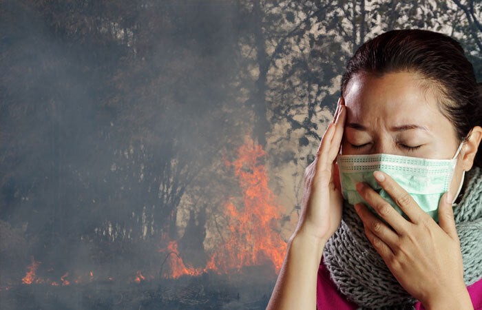 woman in mask and wildfire smoke