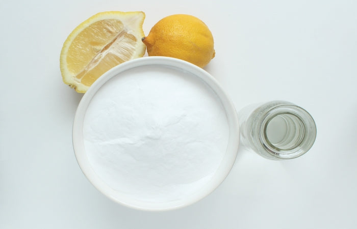 baking soda in a bowl with lemon on the side