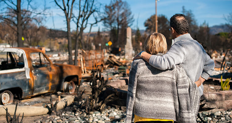 couple watching house torn down