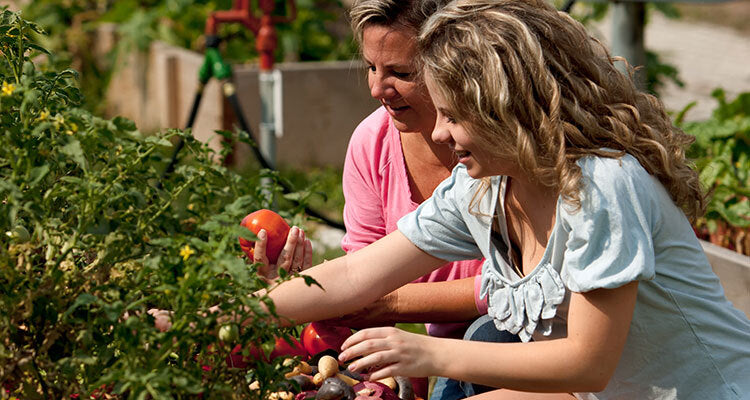Mother and daughter prepare by growing a garden together