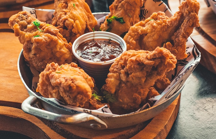 fried chicken in a basket with sauce