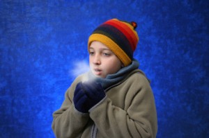 Boy trying to warm his hands
