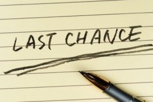 Last chance words written on lined paper with a pen on it