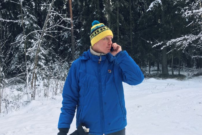 man talking on cell phone in snow