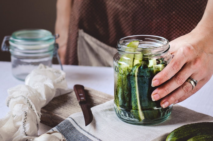 hand holding pickle jar