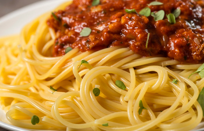 spaghetti topped with marinara sauce