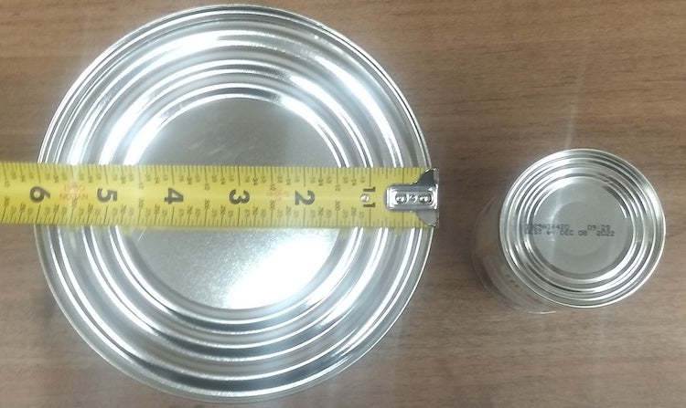 Two cans of different sizes being measured